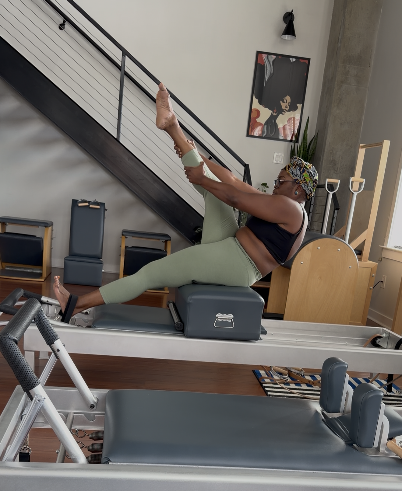 Tia practicing on a Pilates reformer